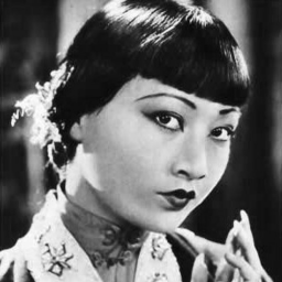 Publicity photo of Anna May Wong from Stars of the Photoplay. Image is in black and white and is a close-up with her head slightly turned towards camera.