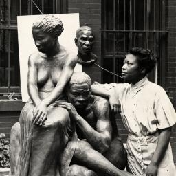 Augusta Savage posing with her sculpture.
