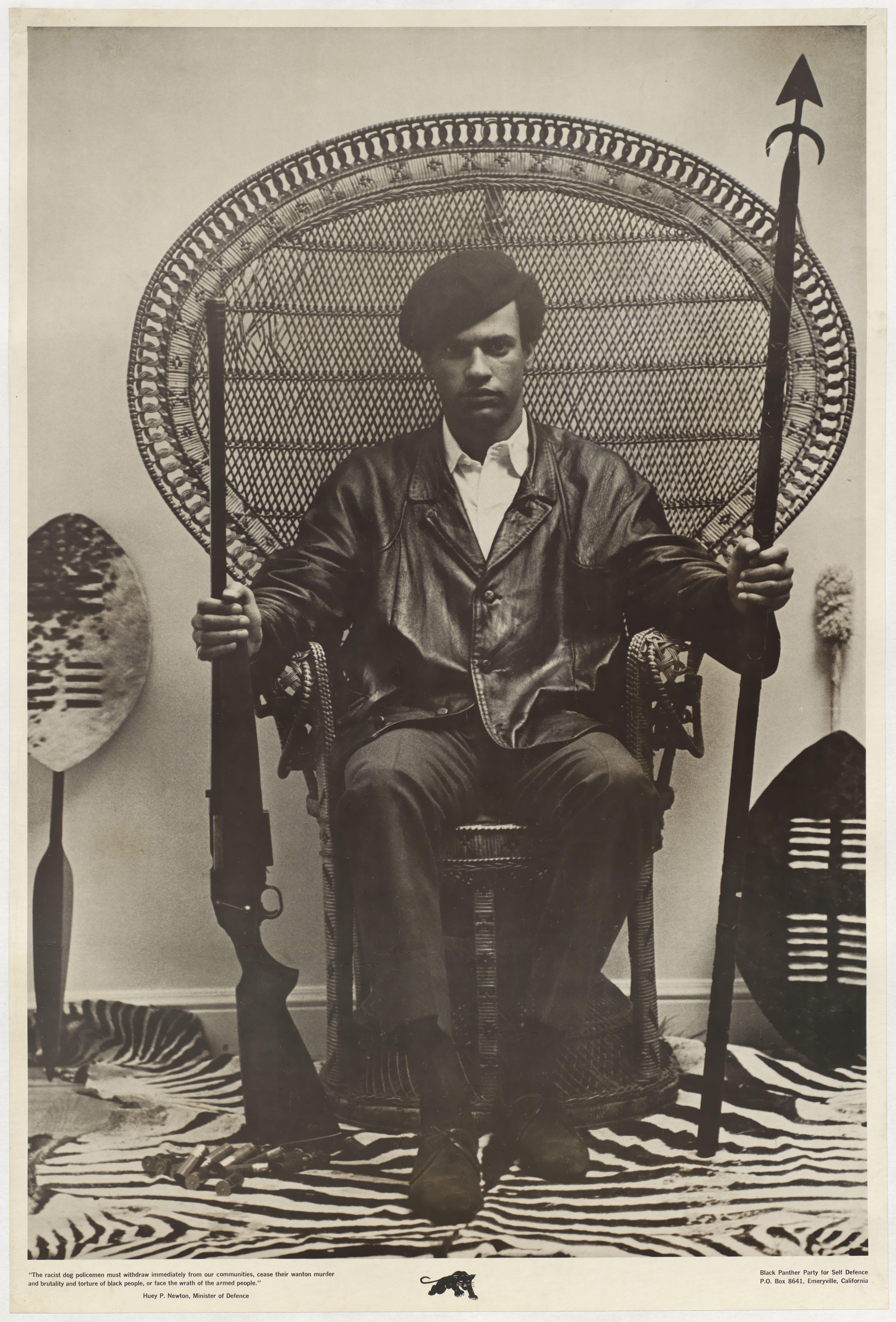 Photo of Huey Newton sitting in a chair