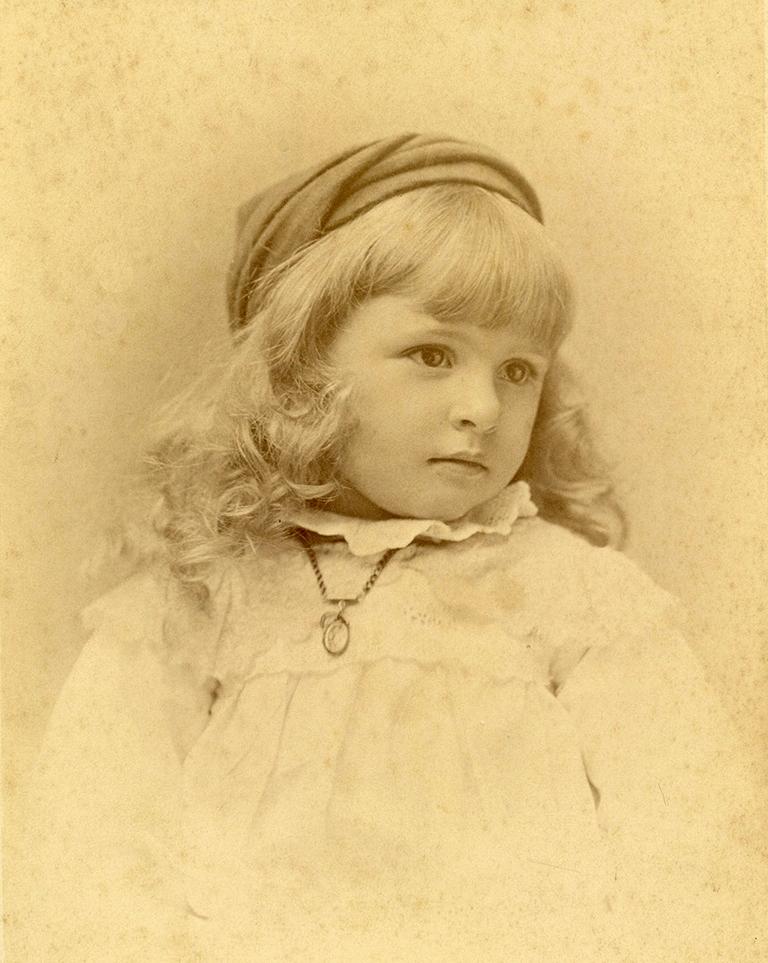 Portrait of Perkins as a young girl dressed in a white dress