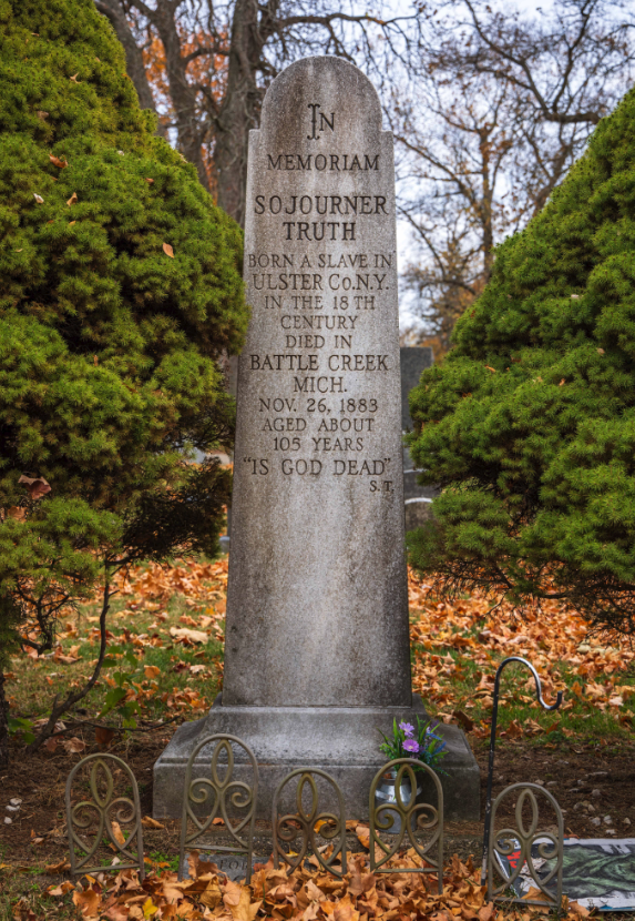 Photo of Truth's tombstone surrounded by fallen leaves.