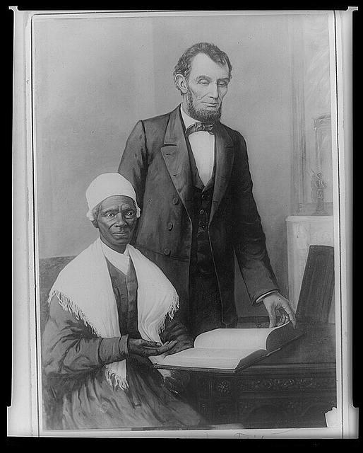 Black and white photo of President Lincoln and Truth showing the Bible given to him by Black Baltimore community members. 