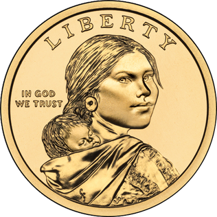 Photo of gold coin featuring Sacagawea. She is looking over her right shoulder and has a baby on her back. The coin has "Liberty" and "In God We Trust" engraved.