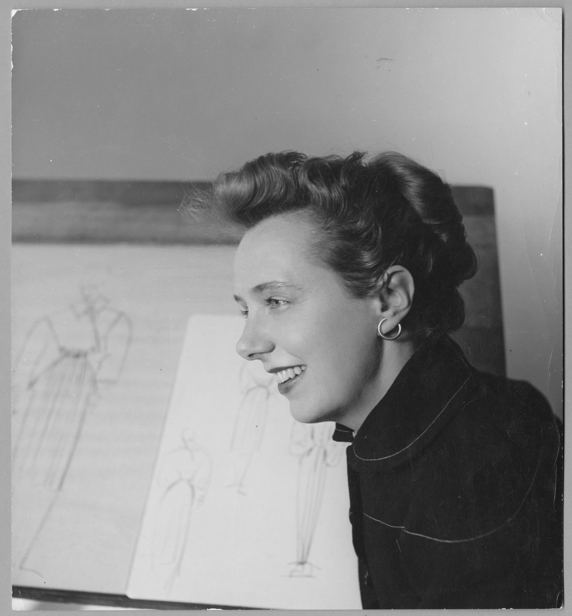 Claire McCardell in front of drawing board