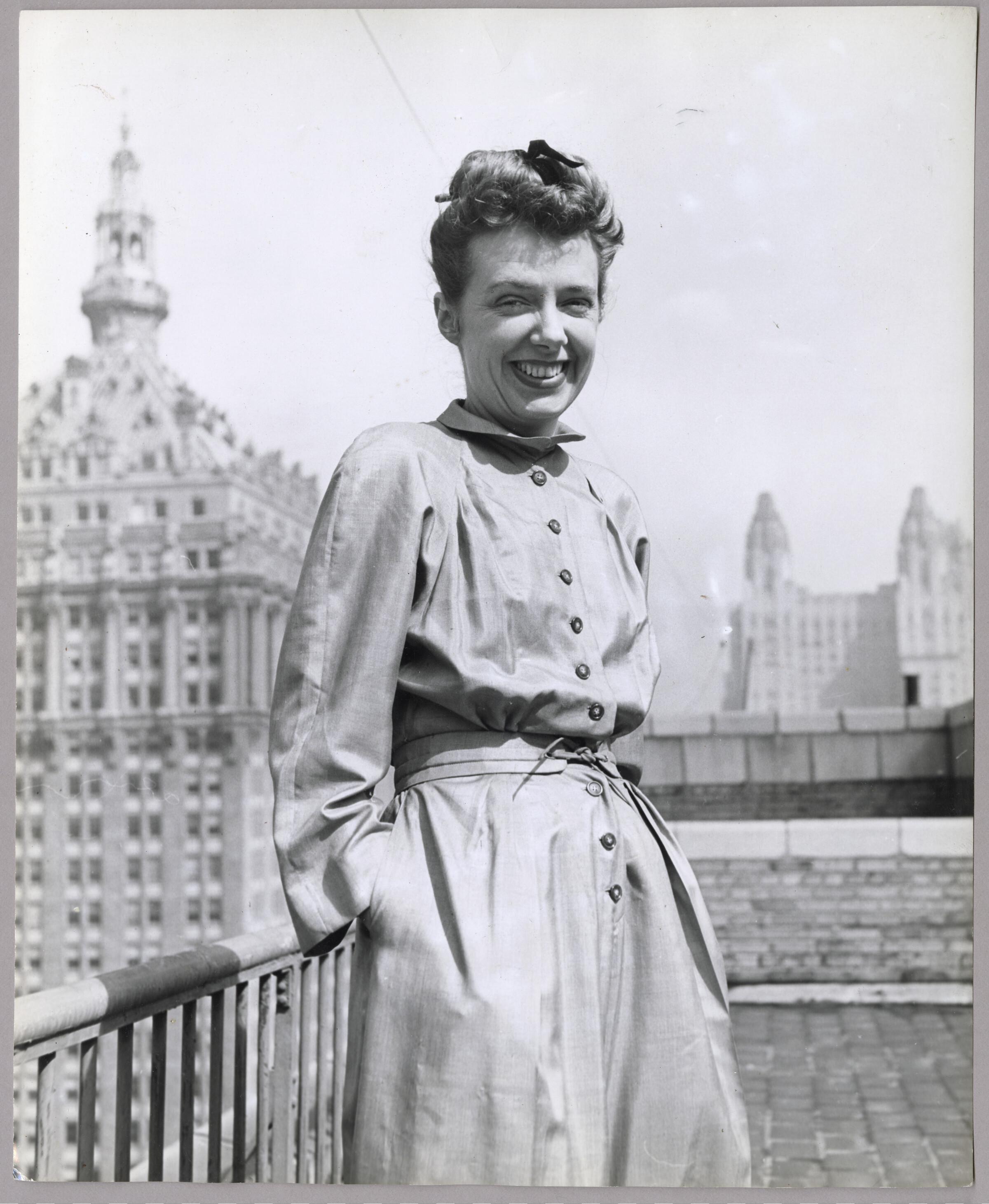 Claire McCardell smiling on balcony