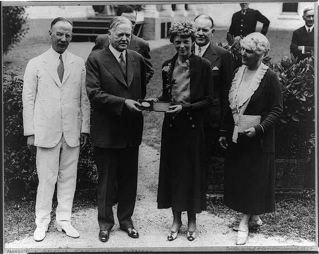 Amelia Earhart with President Hoover, receiving the medal of the National Geographic Society in