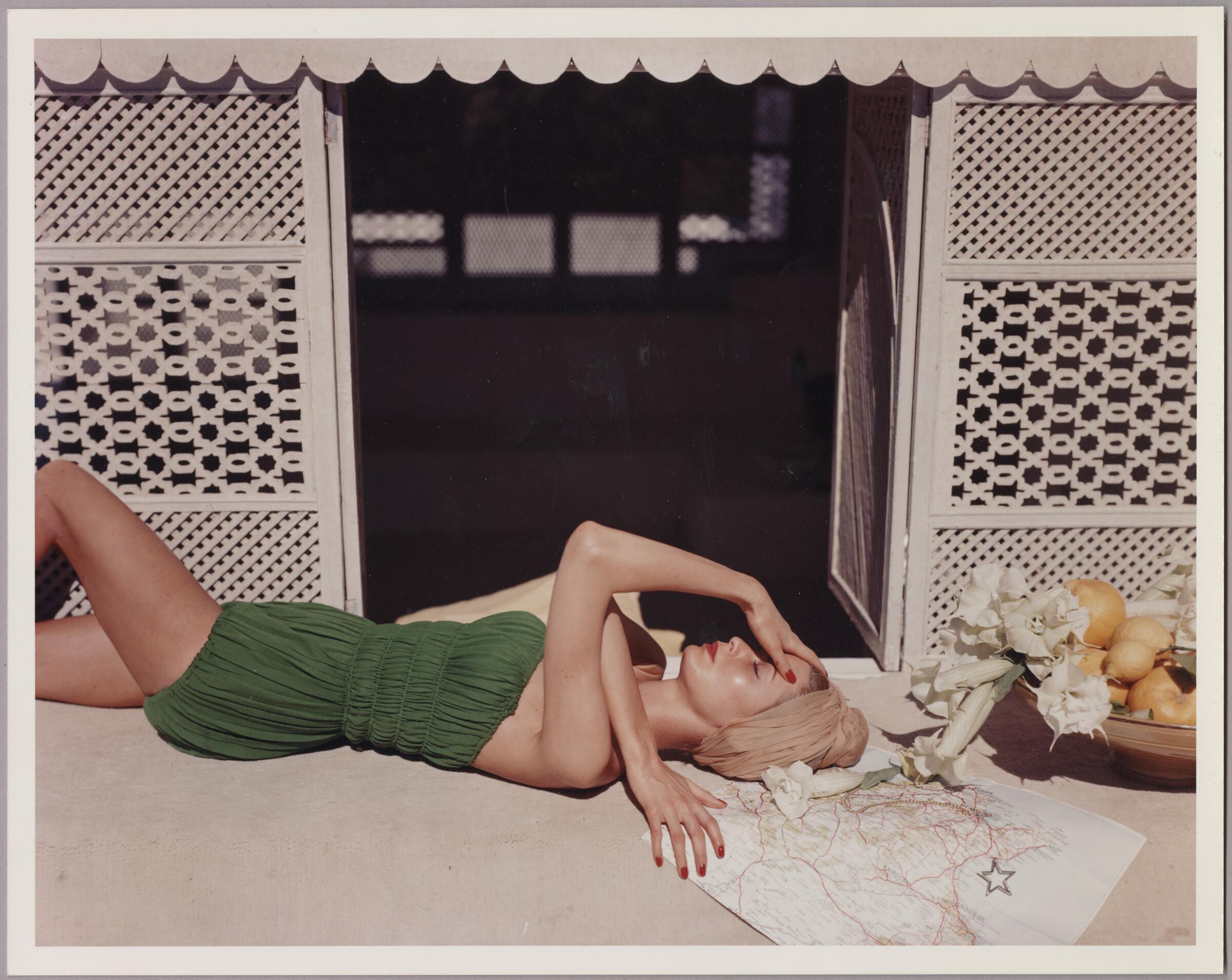 Model wearing green bathing suit designed by Claire McCardell
