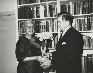 Apgar stands with a man holding an the Apgar Orchid.