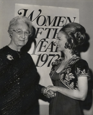 Apgar poses with a woman receiving an award for Woman of the Year.