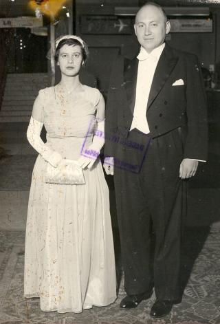 Black & white photo of Esther dressed in an evening gown along with her husband.