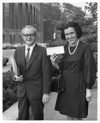 Black and white photo of Rosalyn Yalow (right) and Solomon Berson (left) together. They are both smiling and wearing professional clothing.