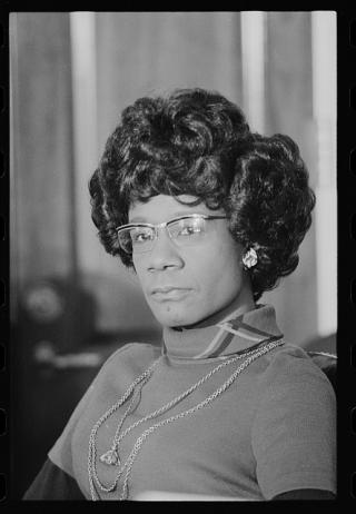 Headshot of Shirley Chisholm, sitting and facing in the direction of the camera.