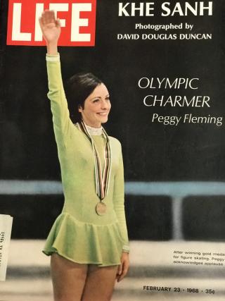 Life Magazine Cover featuring Peggy Fleming in a chartreuse uniform and gold medal. She is raising her right hand and smiling.