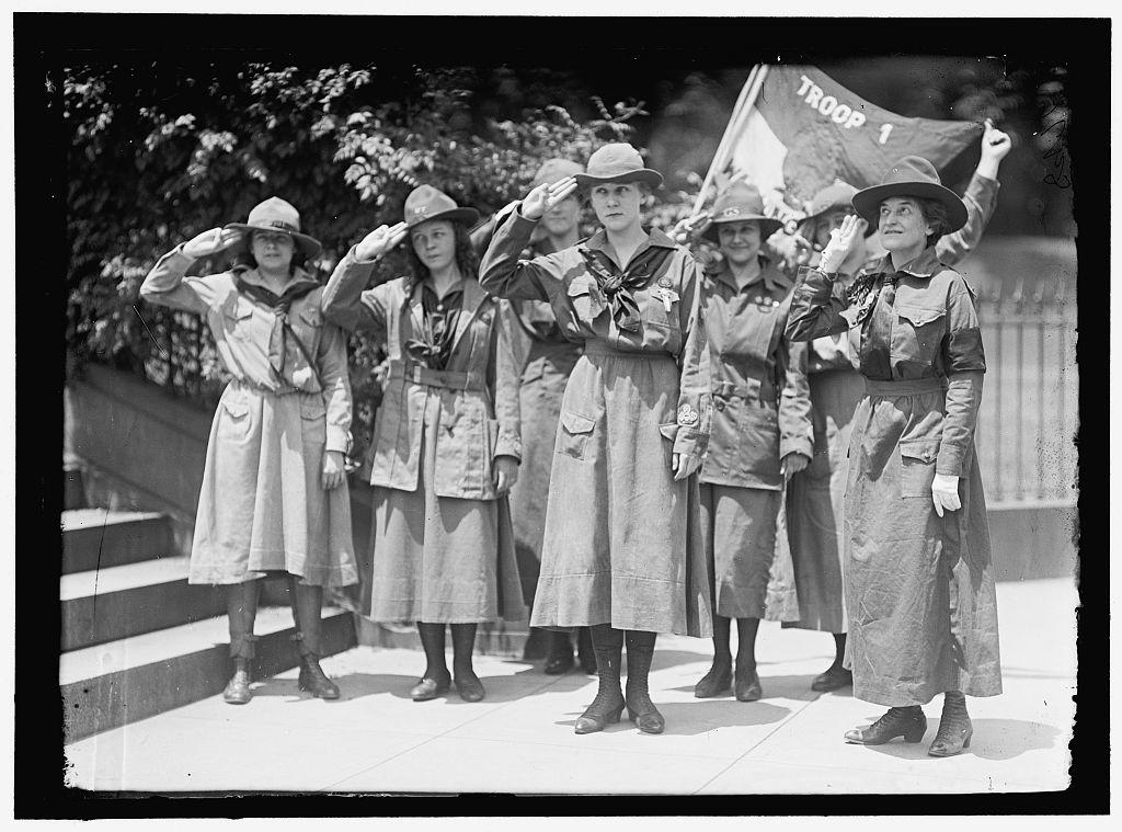 Group of young women saluting; Low on the right, Girl Scouts Troop #1, 1917
