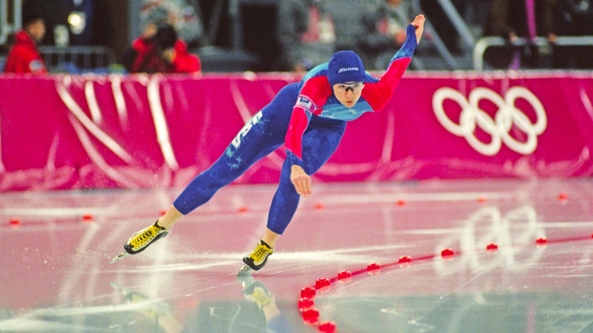 Bonnie Blair skating in uniform on the ice rink.