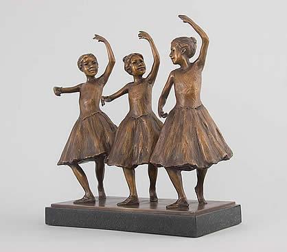 Photo of the bronze Three Ballerinas sculpture. The three ballerinas are in the middle of a dance move, and the dancer on the far right looks at the two to her left.