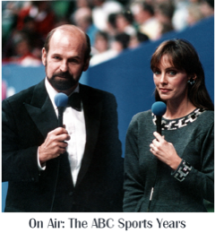 Photo of Peggy Fleming holding a microphone and looking into the camera. She is accompanied by a man in a suit.